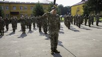 Soldiers with Task Force Illini, 33rd Infantry Brigade Combat Team, Illinois National Guard present arms during a transfer of authority ceremony where Task Force Illini assumed command of Joint Multinational Training Group-Ukraine at Collective Training Center –Yavoriv, Ukraine, July 30. (Photo by Sgt. Gregory Glosser, Task Force Illini Public Affairs)