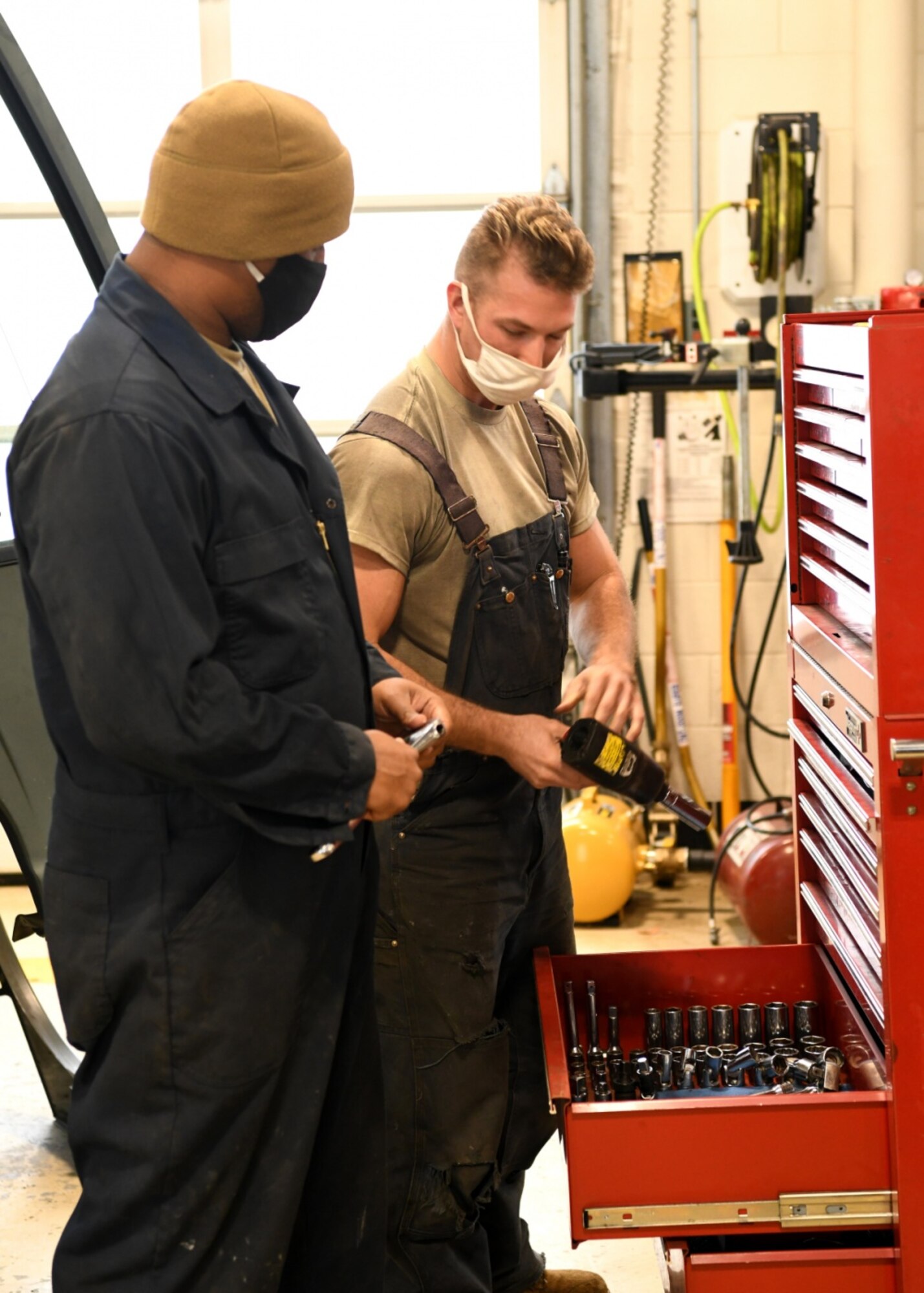 Tech. Sgt. Garrett Goguen 104th Logistics Readiness Squadron Vehicle work leader, Staff Sgt. Zane Collier, and Tech. Sgt. Brendan Allen, 104th Logistics Readiness Squadron heavy mobile mechanics work together to identify a problem in a truck at Barnes Air National Guard Base, October 16, 2020.