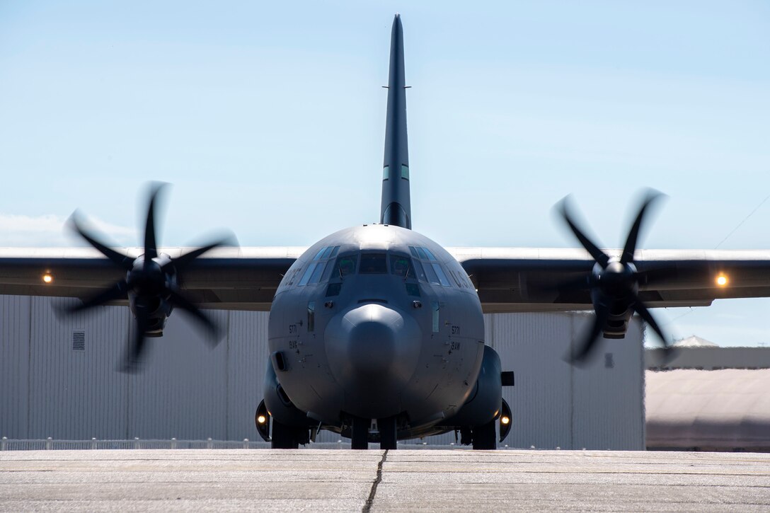 A C-130J sits on a runway.