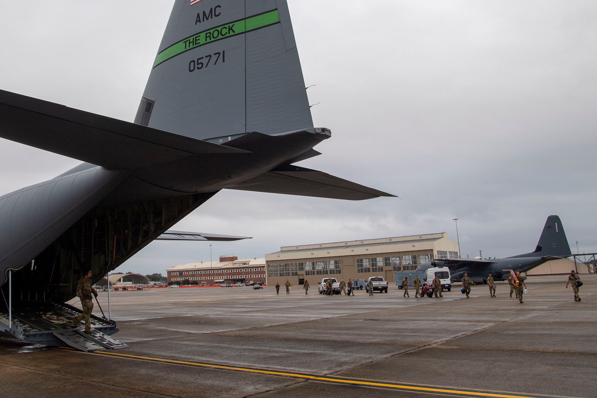 Airmen walk to board a C-130J Super Hercules.