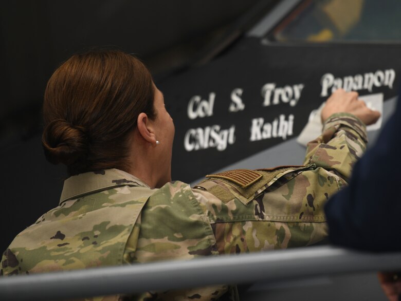 U.S. Air Force Chief Master Sgt. Kathi Glascock, 100th Air Refueling Wing command chief, peels off a stencil revealing her name on a KC-135 Stratotanker aircraft at Royal Air Force Mildenhall, England, Oct. 29, 2020. Normally, only the names of pilots and maintainers are stenciled on aircraft, making the addition of the command chief’s name unique. (U.S. Air Force photo by Staff Sgt. Anthony Hetlage)