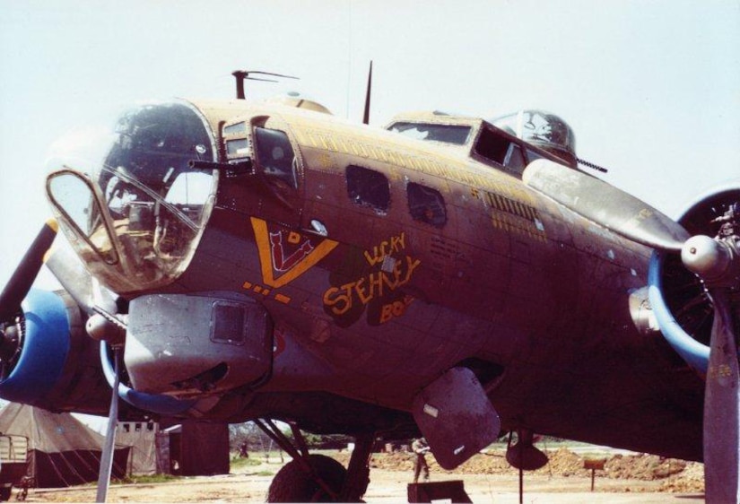 A propeller plane with the name "Lucky Stehley Boy" on its fuselage sits on the tarmac.