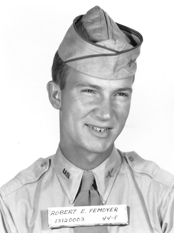 A man in uniform smiles for the camera.