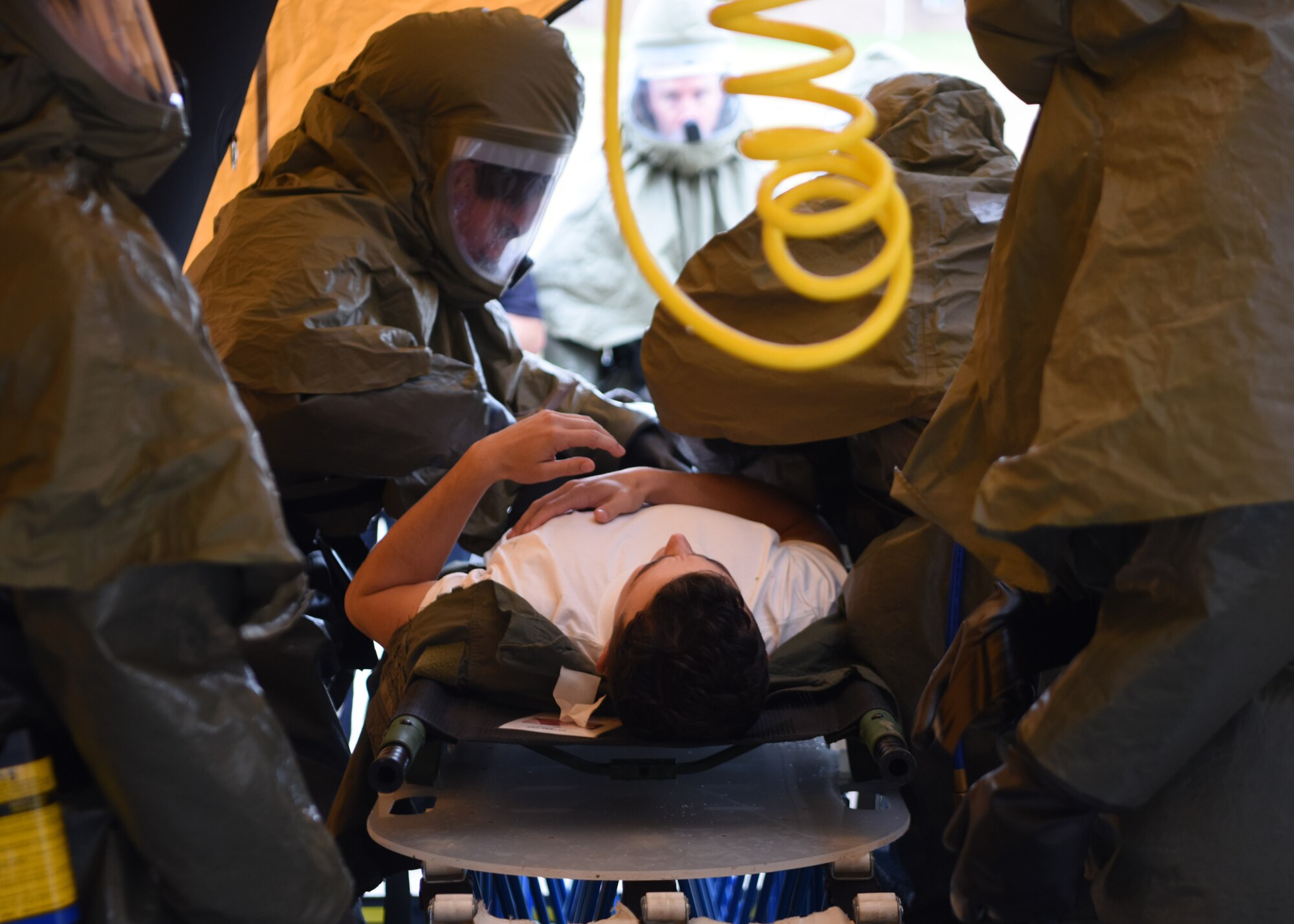 17th Medical Group medics decontaminate a patient during the Ready Eagle exercise on Goodfellow Air Force Base, Texas, Oct. 23, 2020. Patients were moved from a stretcher to a line where they were stripped and decontaminated. (U.S. Air Force photo by Airman 1st Class Ethan Sherwood)