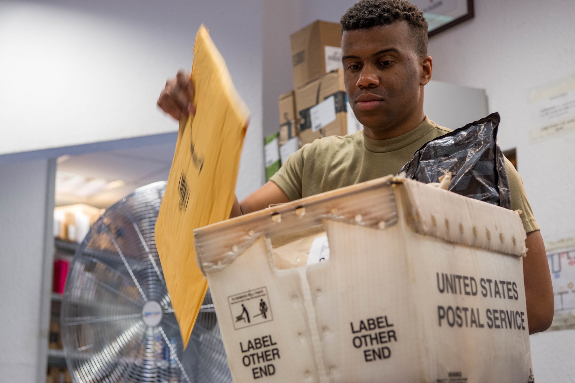 U.S. Air Force Airman 1st Class Michael Troutman, 786th Force Support Squadron military postal clerk, sorts mail at the Northside Post Office at Ramstein Air Base, Germany, Oct. 28, 2020. The post office uses a collection of bins and containers to sort and store mail for customers. (U.S. Air Force photo by Senior Airman Noah Coger)