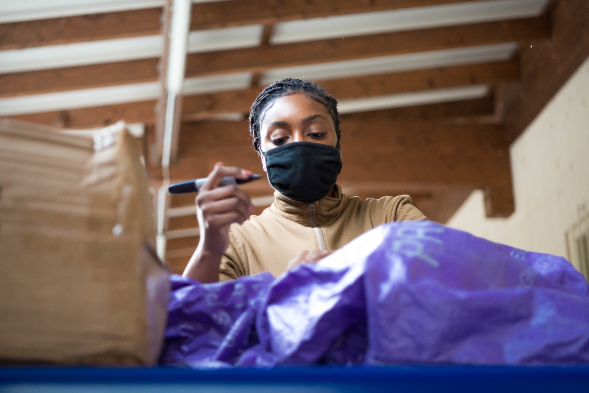 U.S. Air Force Senior Airman Barlitra Dirance, 786th Force Support Squadron military postal clerk, receives parcels at Ramstein Air Base, Germany, Oct. 28, 2020. The Northside Post Office utilizes a stationary conveyor belt, capable of extending into a semi-trailer to expedite processing of incoming packages. (U.S. Air Force photo by Senior Airman Noah Coger)