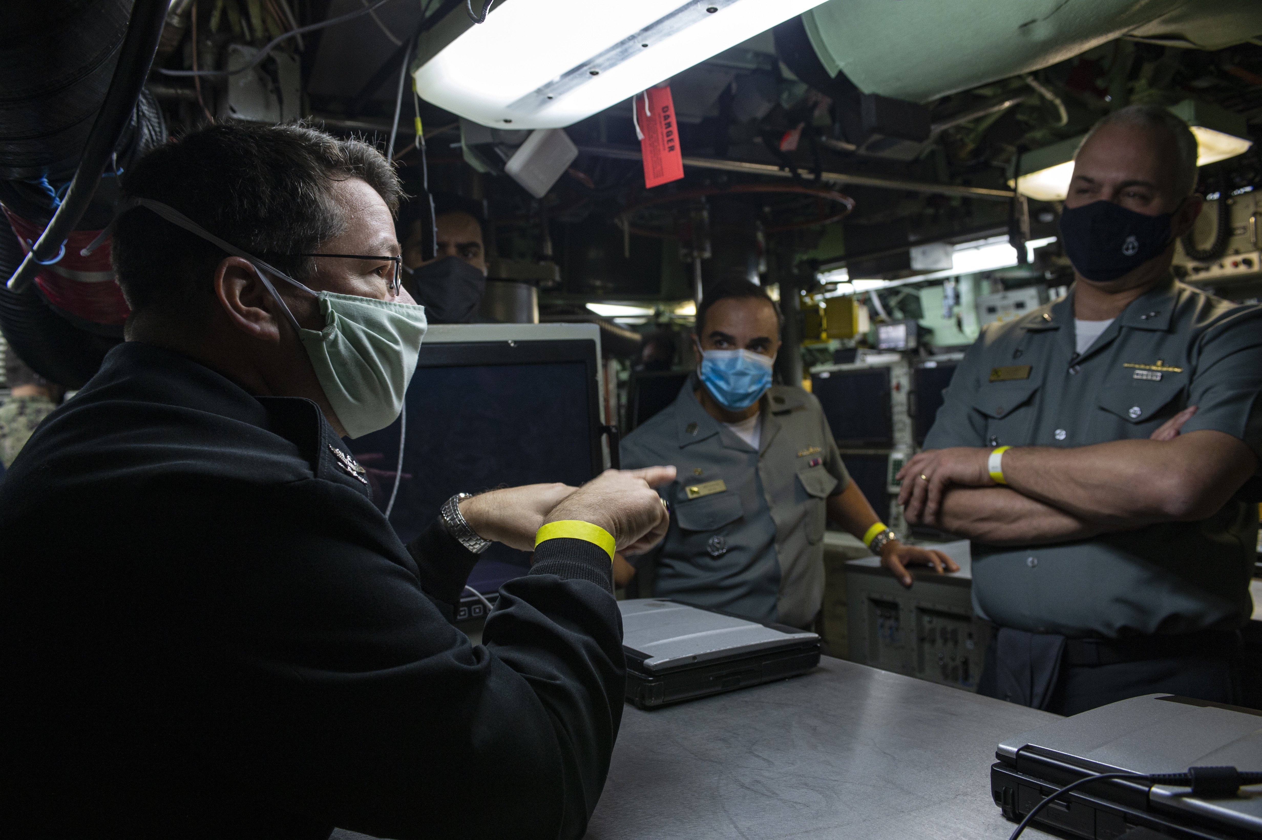 Capt. Daniel Packer, assigned to Commander, Submarine Force Atlantic, explains operations in the control room of the Los Angeles-class attack submarine USS Albany (SSN 753) to Rear Adm.