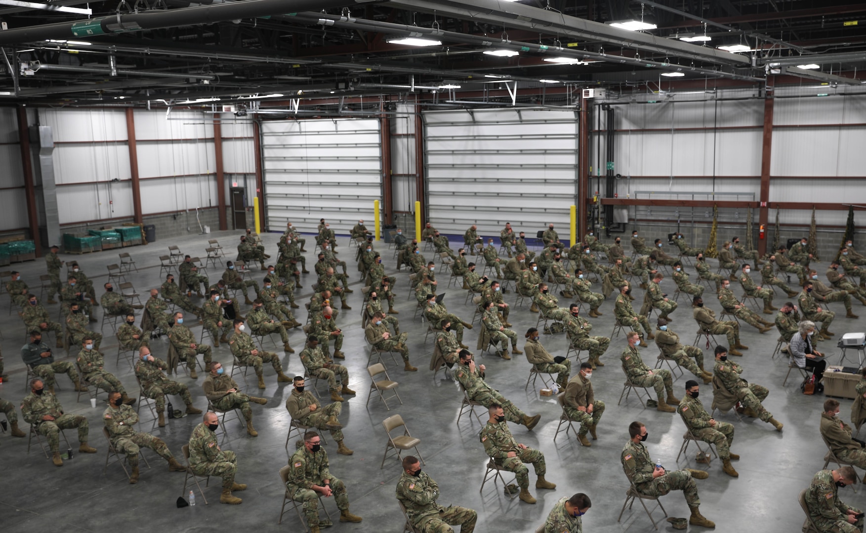 Indiana National Guard Soldiers listen to Brig. Gen. Dale Lyles, the adjutant general, Oct. 30, 2020, before their training mission supporting long-term care facilities throughout the state. More than 1,300 members of the Indiana National Guard will assist with testing and other measures to limit the spread of COVID-19 at the facilities.