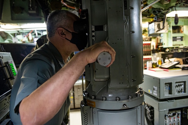 Rear Adm. Thadeu Lobo, commander, Brazilian Submarine Force, looks through a periscope aboard the Los Angeles-class attack submarine USS Albany (SSN 753) Oct. 27, 2020.