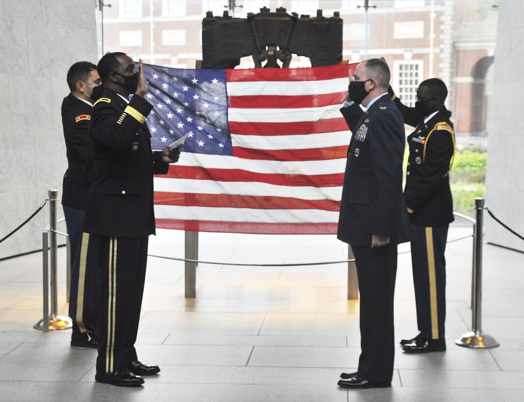 DLA Troop Support Clothing and Textiles Director Col. Justin Swartzmiller, center right, recites the oath of office led by Commander Army Brig. Gen. Gavin Lawrence, center left, during a promotion ceremony in Swartzmiller’s honor at the Liberty Bell Center in Philadelphia October 28, 2020. Swartzmiller was also by family members at the socially distanced ceremony.