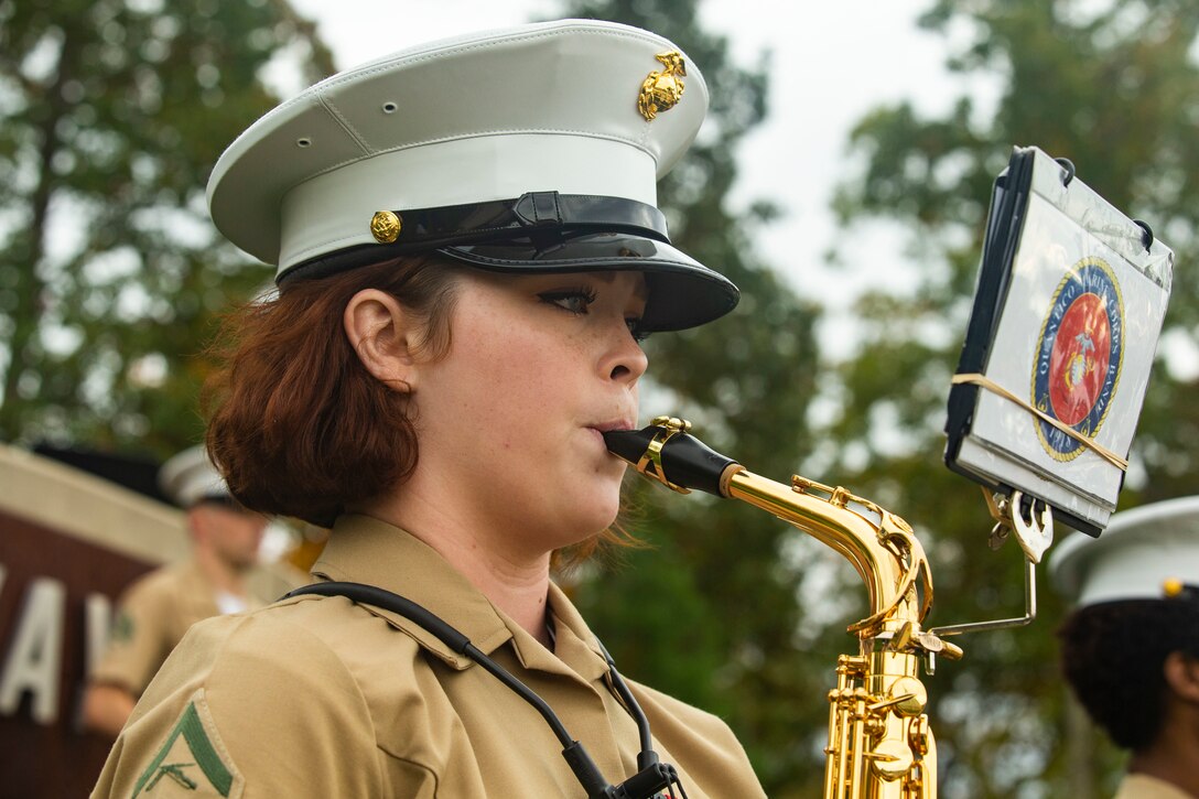 A Marine plays an instrument with the band.