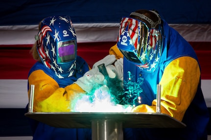MOBILE, Ala. (Oct. 28, 2020) Lolita Zinke, left, the sponsor of the future littoral combat ship USS Santa Barbara (LCS 32), welds her initials into the ship's keel plate during a keel-laying ceremony at Austal USA in Mobile, Alabama, Oct. 27, 2020.