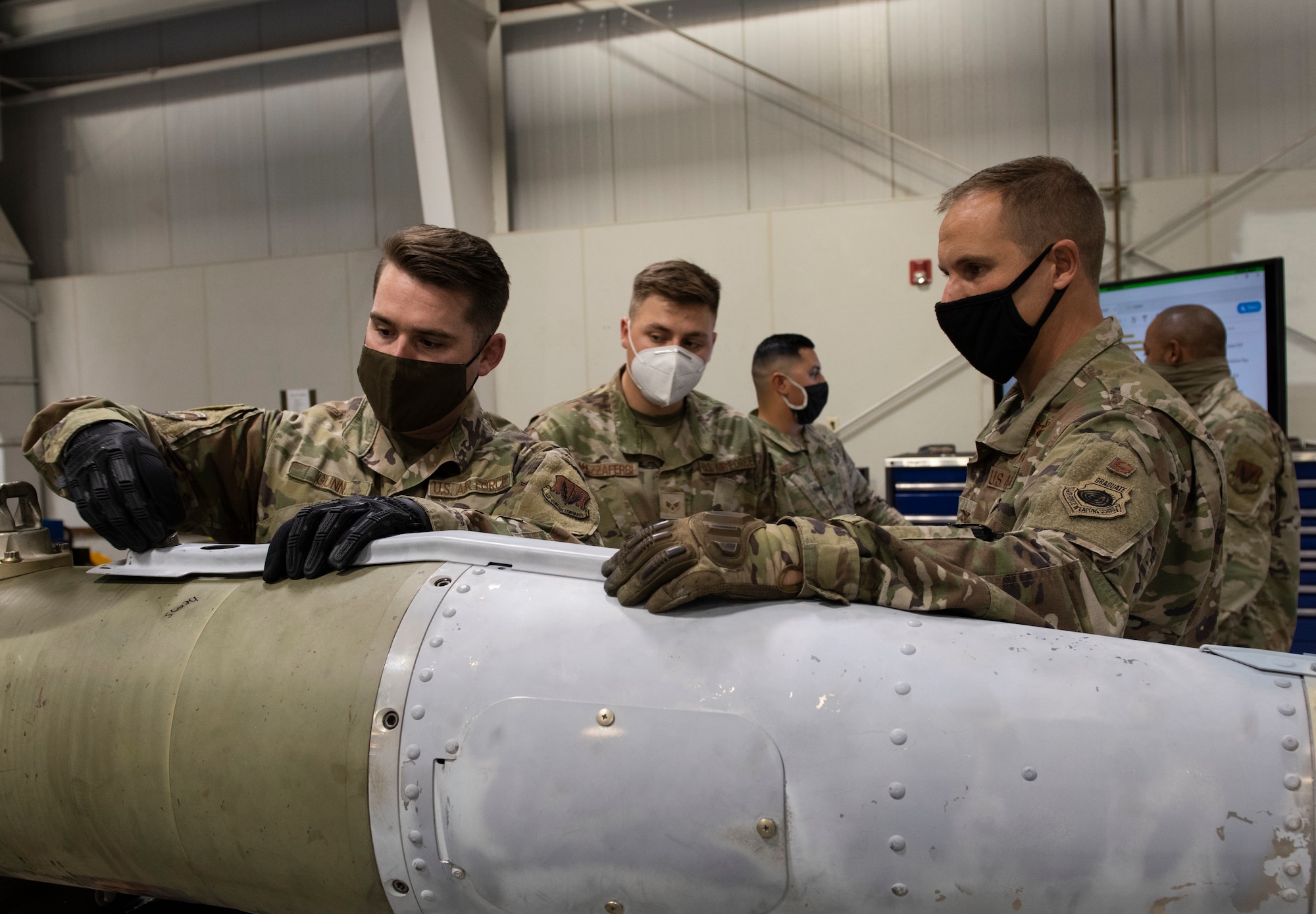 Airmen applies umbilical connector on an umbilical cover.