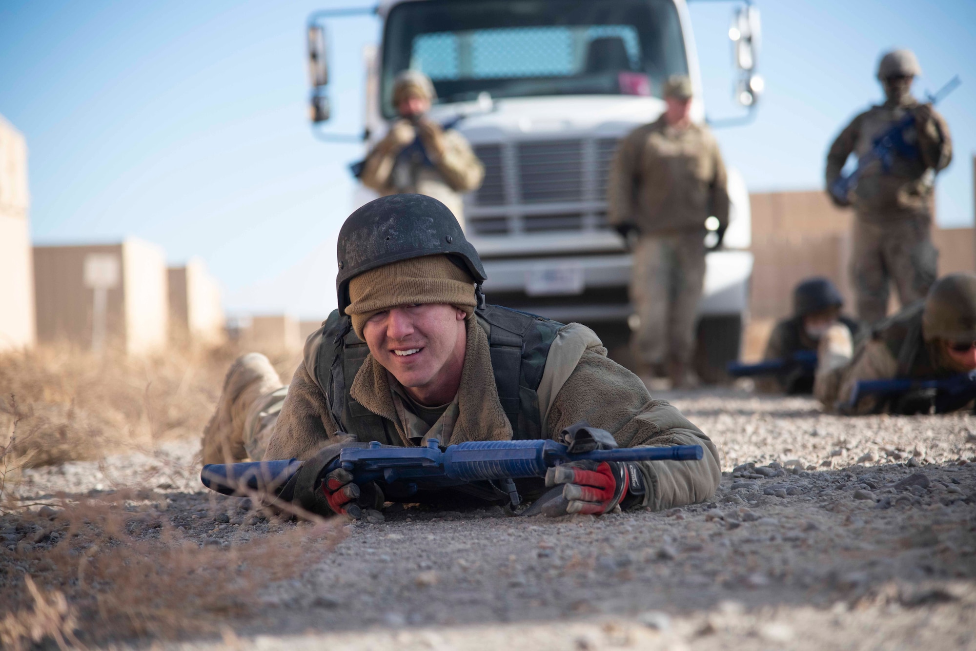 Airmen practice low crawling at the Mountain Home Range Complex, Idaho, Oct. 22, 2020. The 366th Civil Engineer Squadron held exercise Raging TORO to showcase their ability to deploy at a moment’s notice. (U.S. Air Force photo by Airman Andrea Rozoto)