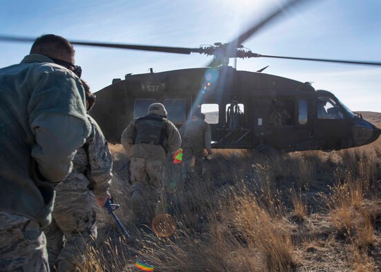 Airmen load onto a U.S. Army Sikorsky UH-60 Black Hawk at the Mountain Home Range Complex, Idaho, Oct. 22, 2020. The 366th Civil Engineer Squadron held exercise Raging TORO to showcase their ability to deploy at a moment’s notice. (U.S. Air Force photo by Airman Andrea Rozoto)