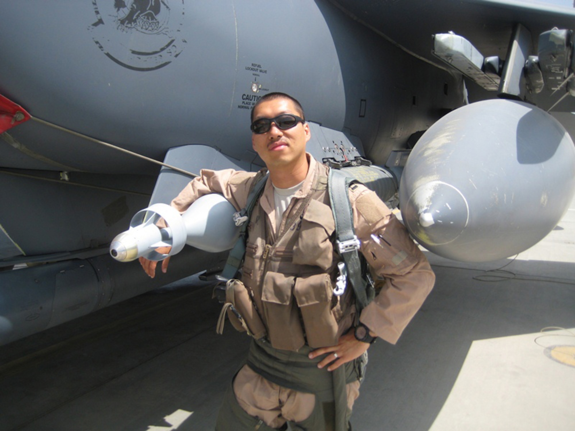 Then Capt. Jay Park, takes a photo before his first deployment sortie, prior to the walk around in front of his jet with his arms around the GBU-12, laser guided bomb.