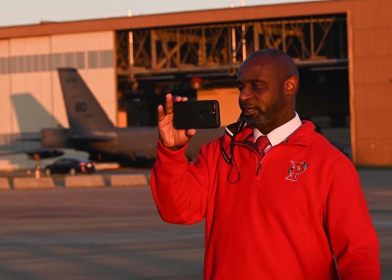A man takes video with his cell phone.