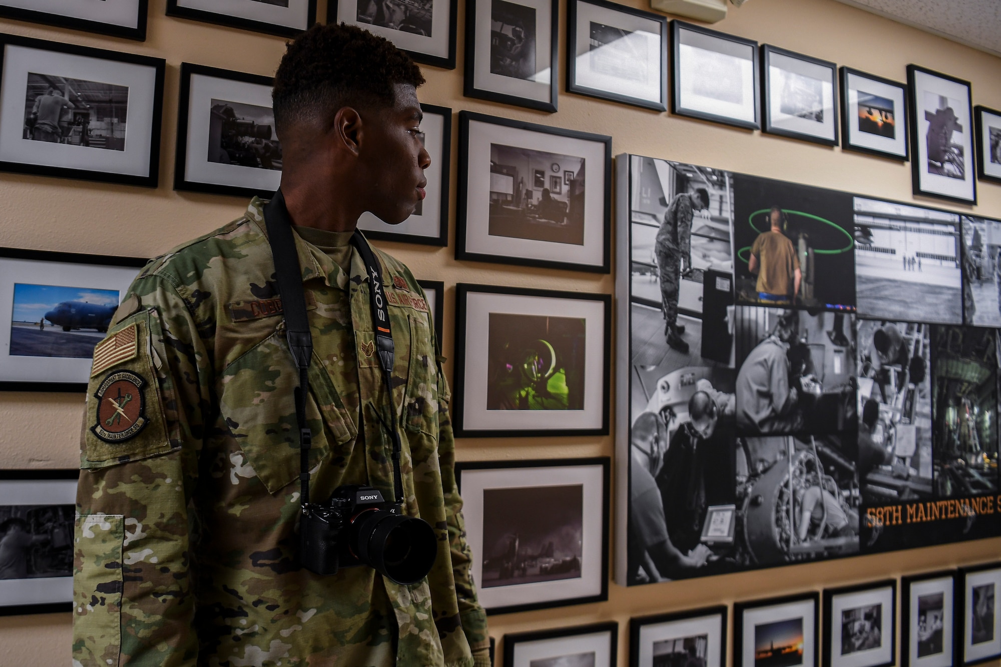 An Airmen looks at his legacy wall project
