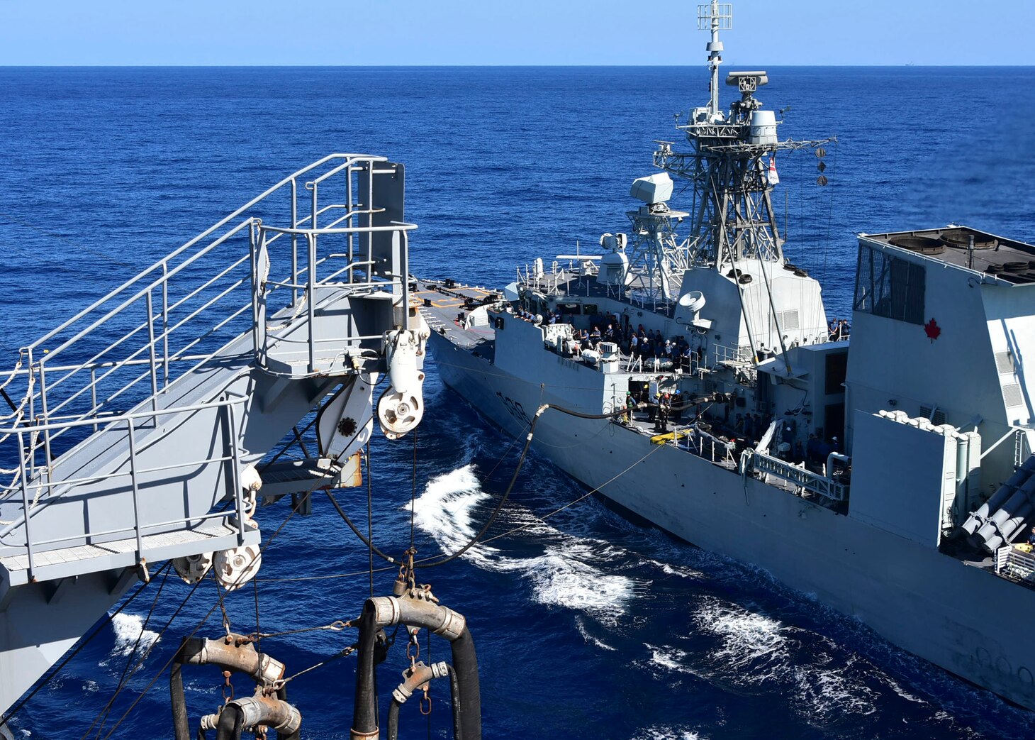 PHILIPPINE SEA (Oct. 25, 2020) – The U.S. Navy Military Sealift Command Henry J. Kaiser-class fleet replenishment oiler USNS Tippecanoe (T-AO 199), left, refuels the Royal Canadian Navy Halifax-class frigate HMCS Winnipeg (FFH 338) during an underway replenishment prior to participating in Keen Sword. Keen Sword is a joint, bilateral, biennial field-training exercise involving U.S. military and Japan Self-Defense Force personnel, designed to increase combat readiness and interoperability of the Japan-U.S. alliance. (US. Navy photo by Christopher Bosch)