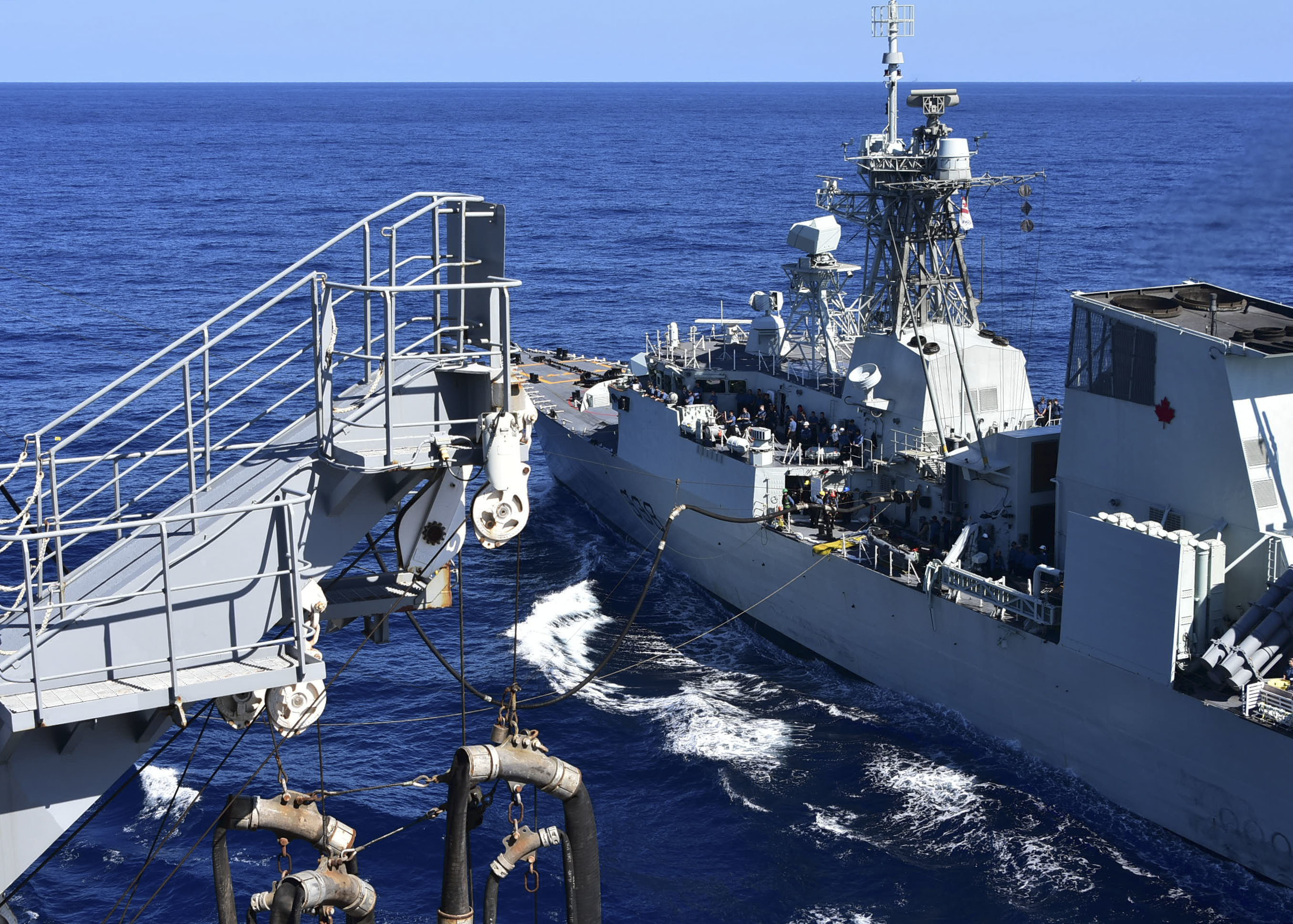 PHILIPPINE SEA (Oct. 25, 2020) – The U.S. Navy Military Sealift Command Henry J. Kaiser-class fleet replenishment oiler USNS Tippecanoe (T-AO 199), left, refuels the Royal Canadian Navy Halifax-class frigate HMCS Winnipeg (FFH 338) during an underway replenishment prior to participating in Keen Sword. Keen Sword is a joint, bilateral, biennial field-training exercise involving U.S. military and Japan Self-Defense Force personnel, designed to increase combat readiness and interoperability of the Japan-U.S. alliance. (US. Navy photo by Christopher Bosch)