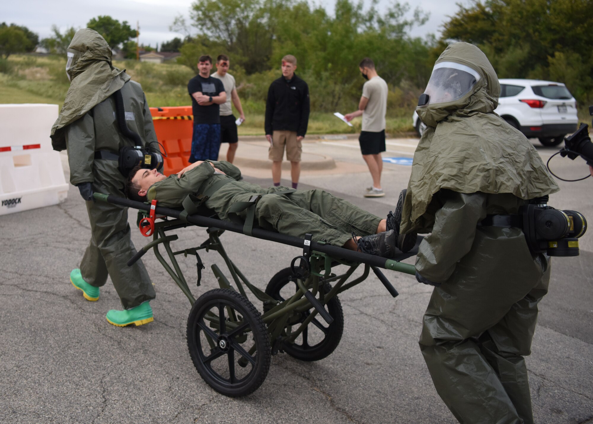 17th Medical Group medics roll a volunteer casualty to be decontaminated during the Ready Eagle exercise on Goodfellow Air Force Base, Texas, Oct. 23, 2020. A decontamination tent was used to decontaminate patients exposed to specific hazards. (U.S. Air Force photo by Airman 1st Class Ethan Sherwood)