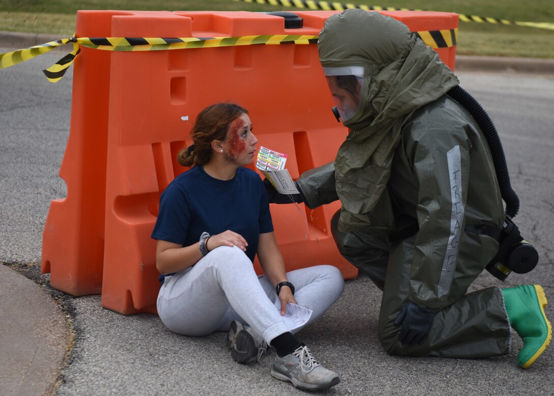 A 17th Medical Group medic checks on a patient who has been in a car accident during the Ready Eagle exercise on Goodfellow Air Force Base, Texas, Oct. 23, 2020. Medics checked each patient and marked them according to the severity of their injuries. (U.S. Air Force photo by Airman 1st Class Ethan Sherwood)