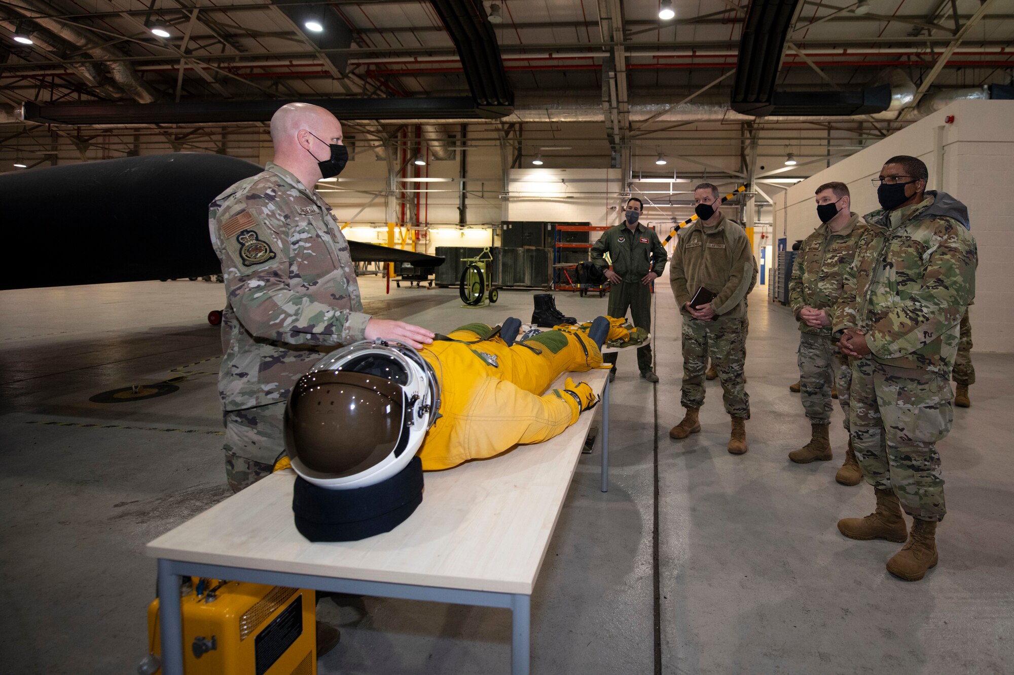 U.S. Air Force Tech. Sgt. Benjamin Landreneau, left, 99th Expeditionary Reconnaissance Squadron physiological support detachment supervisor, briefs the Third Air Force command team and 501st Combat Support Wing leadership about the capabilities of the Lockheed U-2 aircraft at Royal Air Force Fairford, England, Oct. 28, 2020. The Third Air Force command team toured six bases in the 501st CSW as part of a new commander’s immersion tour. (U.S. Air Force photo by Senior Airman Jennifer Zima)