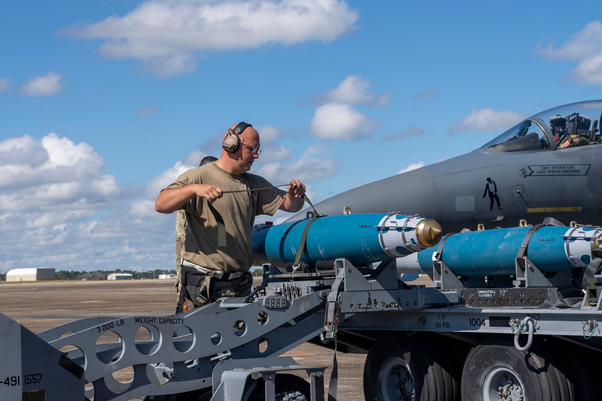An Airman moves a training munition onto a jammer.