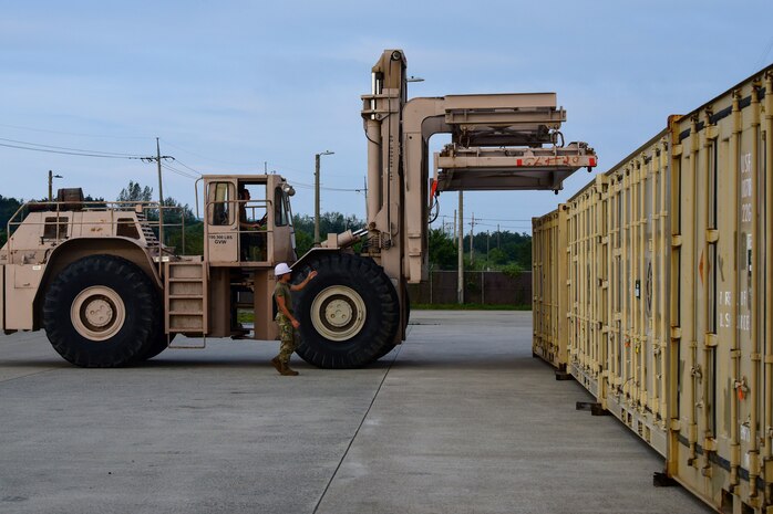 Airman 1st Class Aaron Klawitter, 8th Maintenance Squadron management stockpile technician guides Staff Sgt. Brett Mohney, 8th MXS ammo flight munitions storage and handling technician, at Kunsan Air Base, Republic of Korea, Aug. 28, 2020. Containers of unserviceable munitions are shipped back to the United States twice a year and frees up crucial storage for resupply, increasing mission readiness capabilities of the 8th Fighter Wing. (U.S. Air Force photo by Senior Airman Jessica Blair)