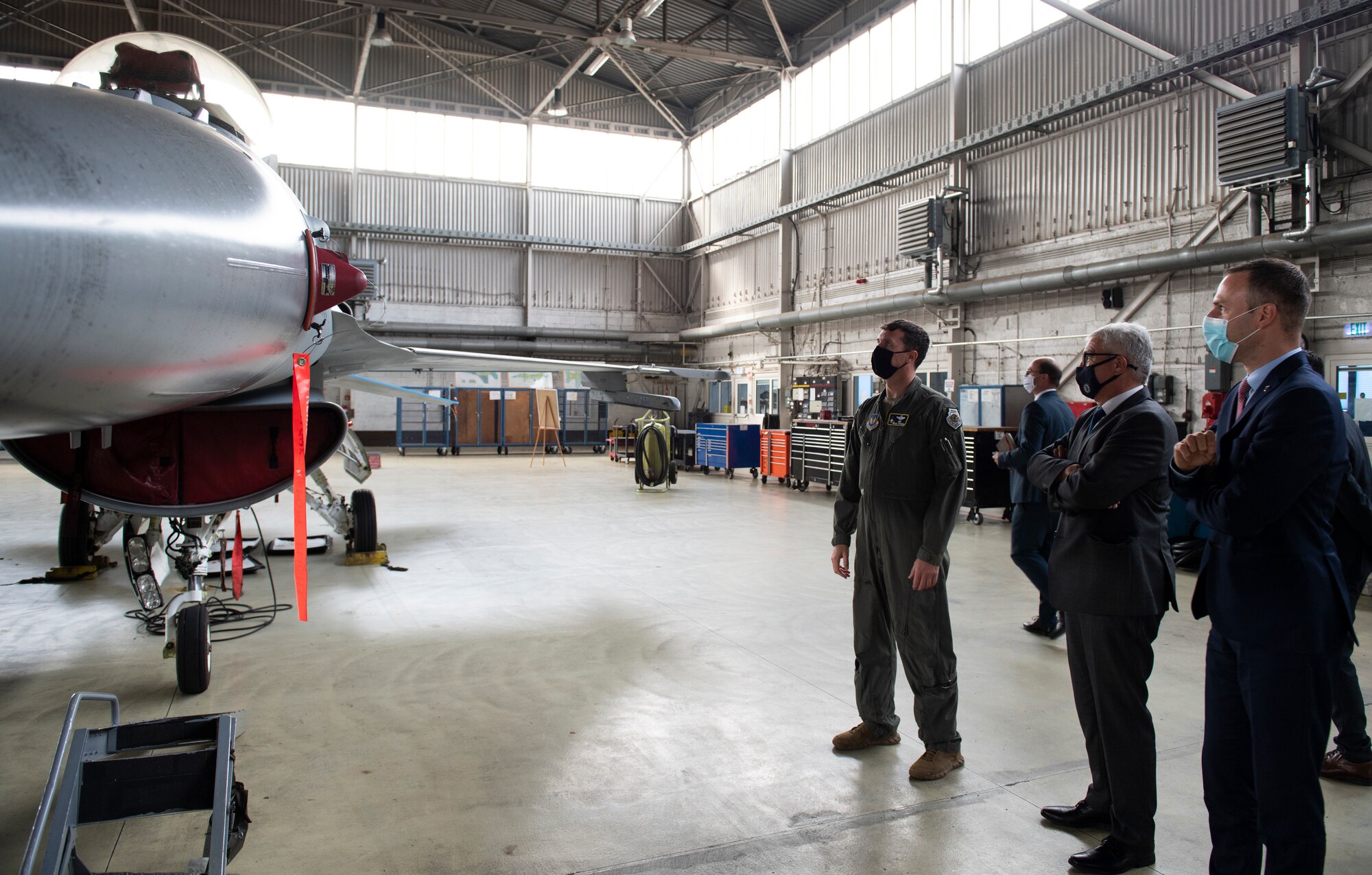 U.S. Air Force Col. David Epperson, 52nd Fighter Wing commander, gives a tour of an F-16 Fighting Falcon in a hangar at Spangdahlem Air Base, Germany, Aug. 28, 2020. Epperson led the tour and gave German parliamentarians insight on the base mission and partnership support. (U.S. Air Force photo by Airman 1st Class Alison Stewart)
