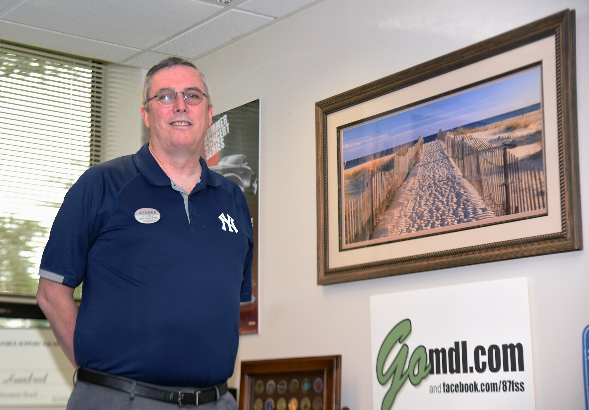 Photo of an individual posing in his office.