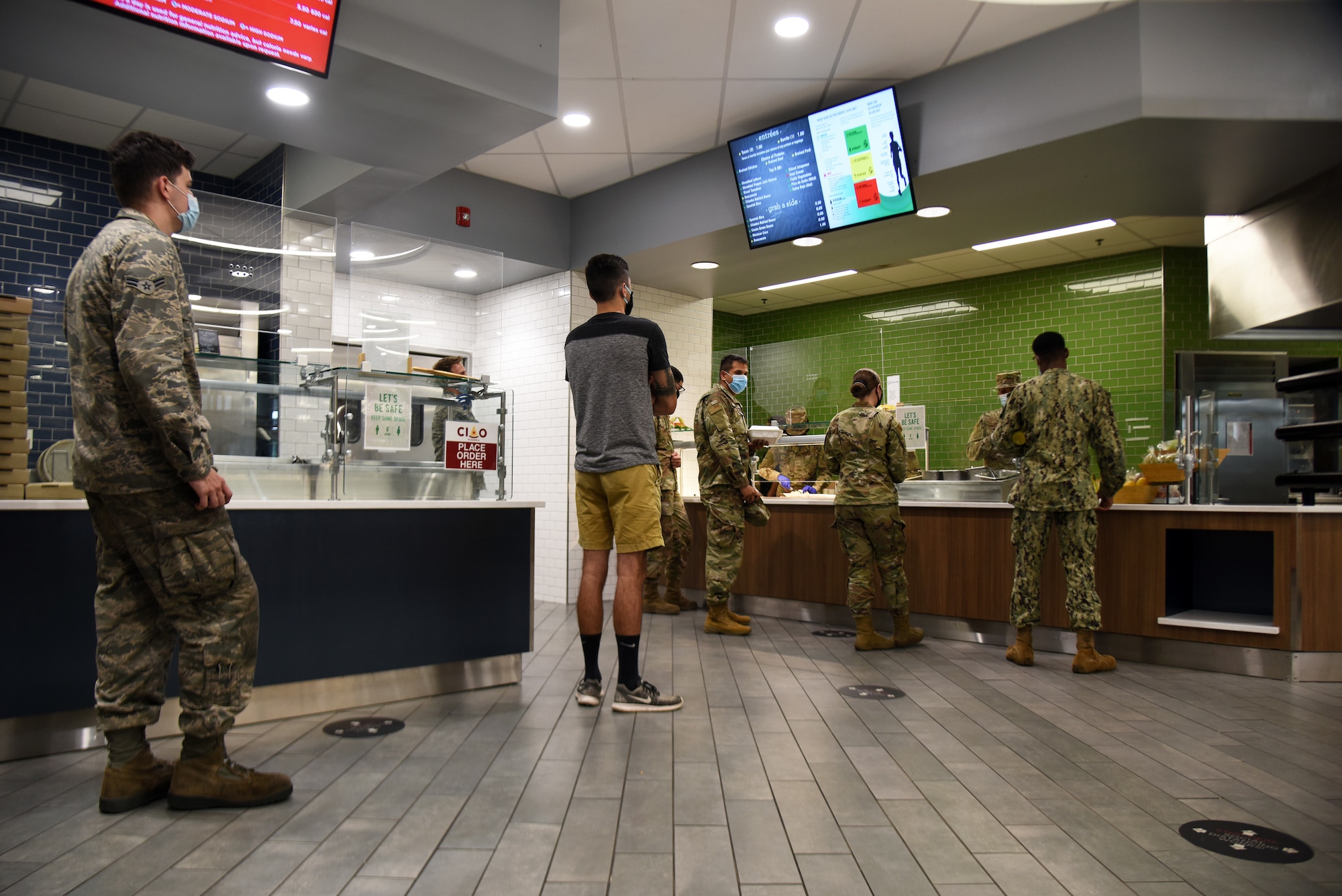 Photo of Airmen waiting in the DFAC line.