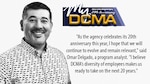 Smiling man standing against the wall with a My DCMA 20th anniversary logo on the photo