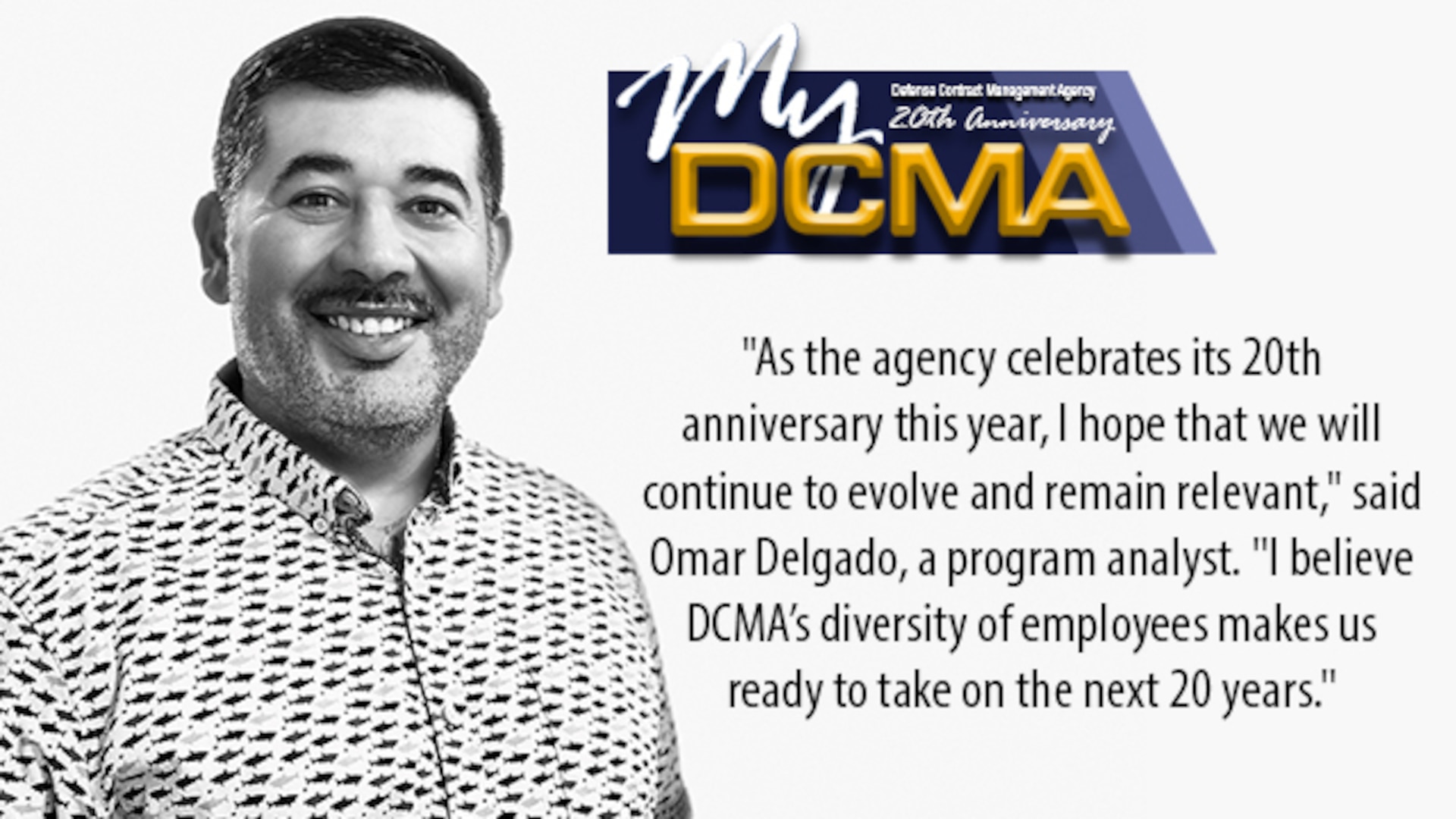Smiling man standing against the wall with a My DCMA 20th anniversary logo on the photo