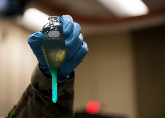 U.S. Air Force Airman 1st Class Michael Mallick, a nondestructive inspection specialist with the 1st Special Operations Maintenance Squadron, inspects suspended sediment in a centrifuge at Hurlburt Field, Florida, Aug. 27, 2020. NDI specialists ensure aircraft safety by using magnetic particles, fluorescent penetrants, and eddy currents to detect cracks in aircraft parts invisible to the naked eye. (U.S. Air Force photo by Airman 1st Class Robyn Hunsinger)