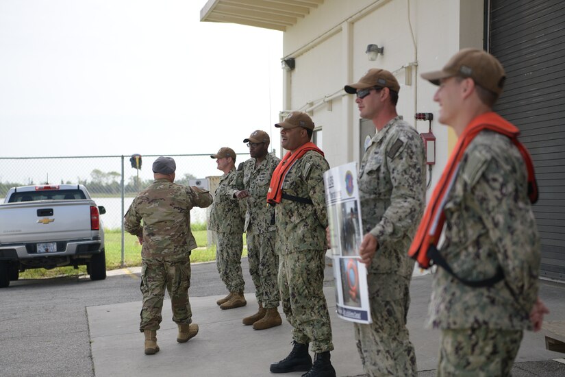 Chief Master Sgt. Jason Colón, left, 628 Air Base Wing Command Chief, introduces himself to Sailors at the 628th Logistics Readiness Squadron Waterfront Operations at Joint Base Charleston, S.C., Aug. 26, 2020. Colón rose through the ranks as a Special Operations Weather Technician and has been in the Air Force for 30 years.