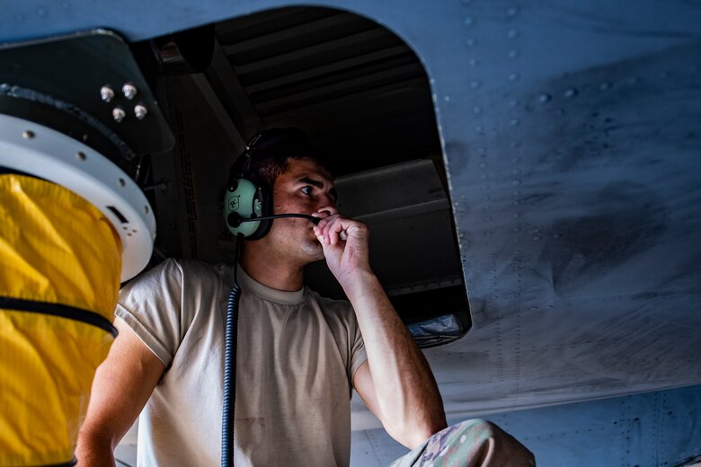 Tech. Sgt. Ben Sardon, 911th Aircraft Maintenance Squadron communication and navigation systems technician, talks to fellow Airmen while inspecting a C-17 Globemaster III during a home station check at the Pittsburgh International Airport Air Reserve Station, Pennsylvania, July 20, 2020.