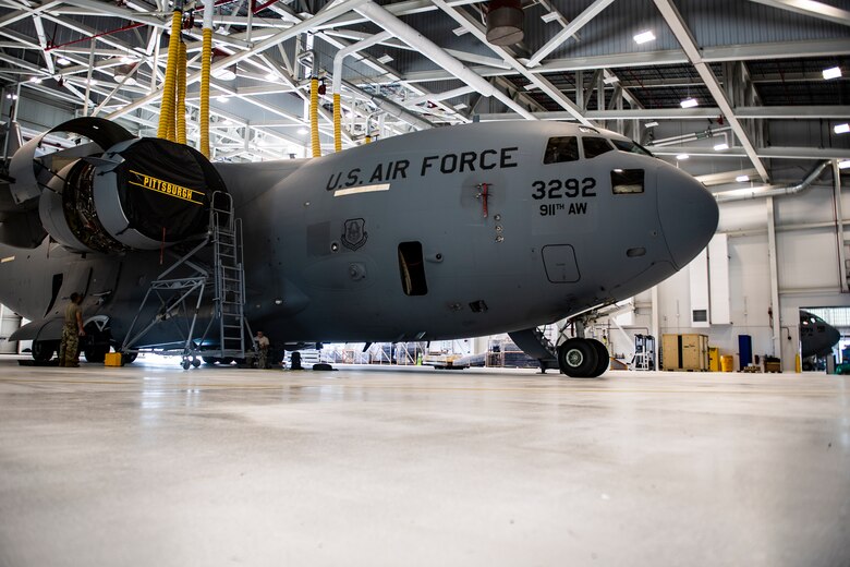 Two C-17 Globemaster III aircraft receive maintenance inside the new two-bay hangar at the Pittsburgh International Airport Air Reserve Station, Pennsylvania, July 20, 2020.