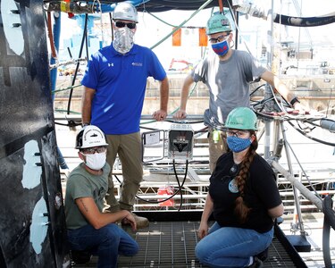 Electrical Engineering Technician Aaron Taylor, Electronics Mechanic Anthony Qualtieri, Electronics Supervisor Lou Scala, and Electronics Apprentice Amanda Mason helped develop the Yagi Passive Antenna Systems for the San Francisco Project.