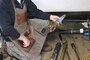 Phil Wright, clock repairer and owner of Tower Clock Company, Charleston, Ohio, holds a cleaned and restored gear from the clock mechanism.