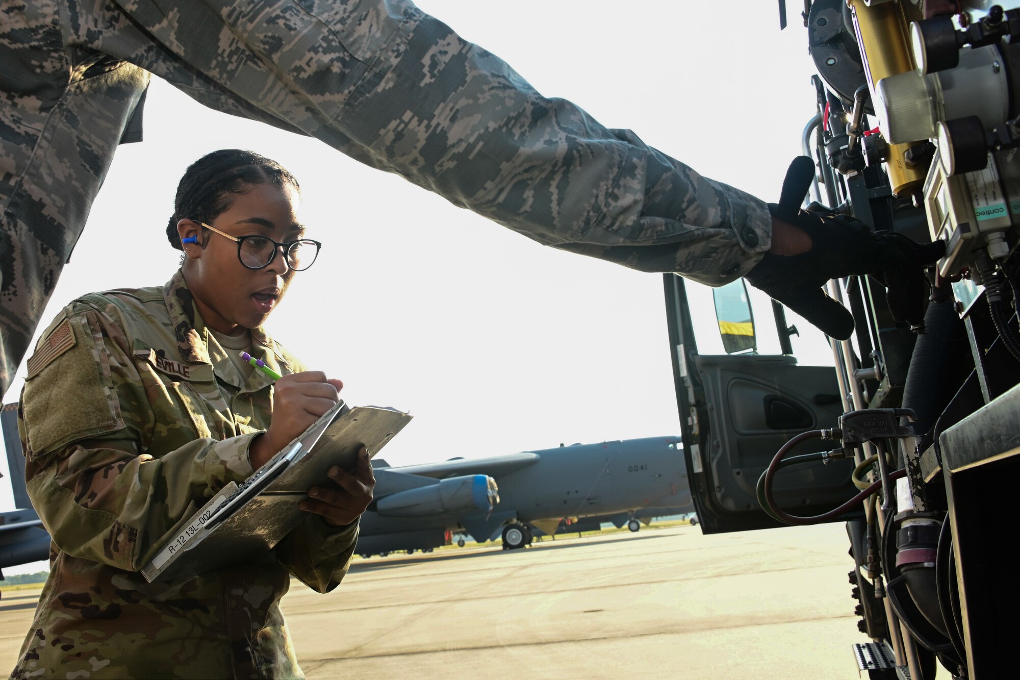 Photo of Airman reading gauges on a fuel truck.