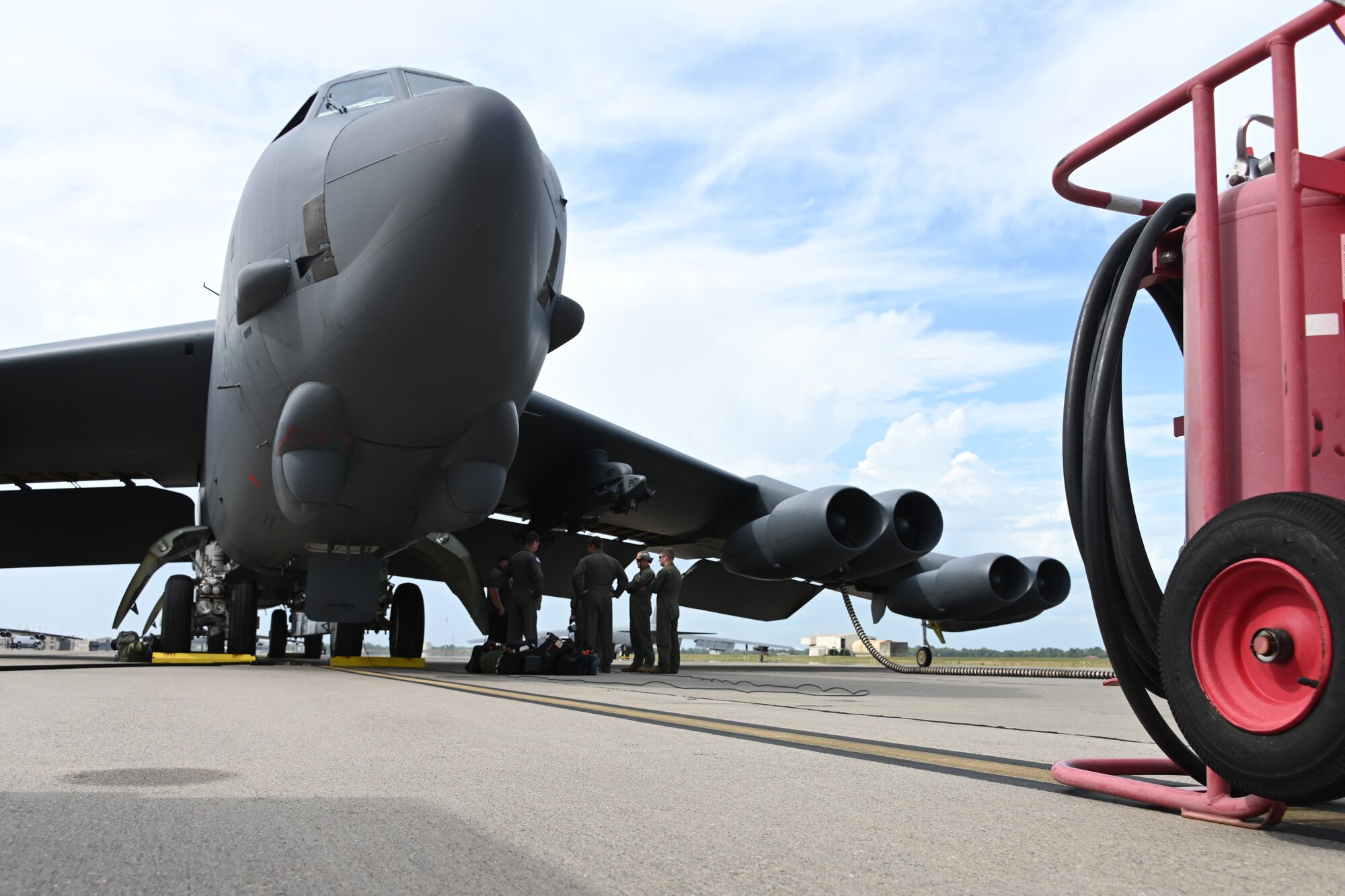Photo of Airmen gathering at a B-52.