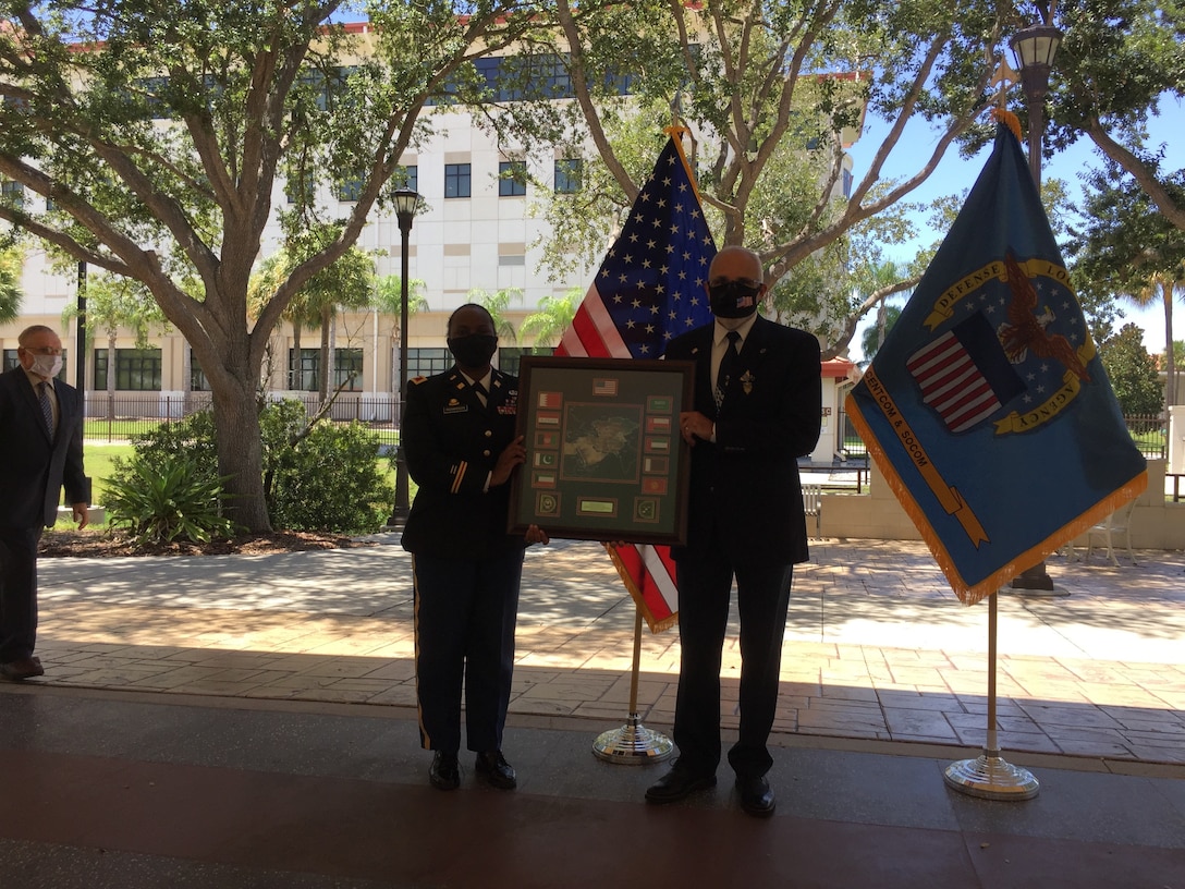 The commander presents the honoree with a departure plaque.