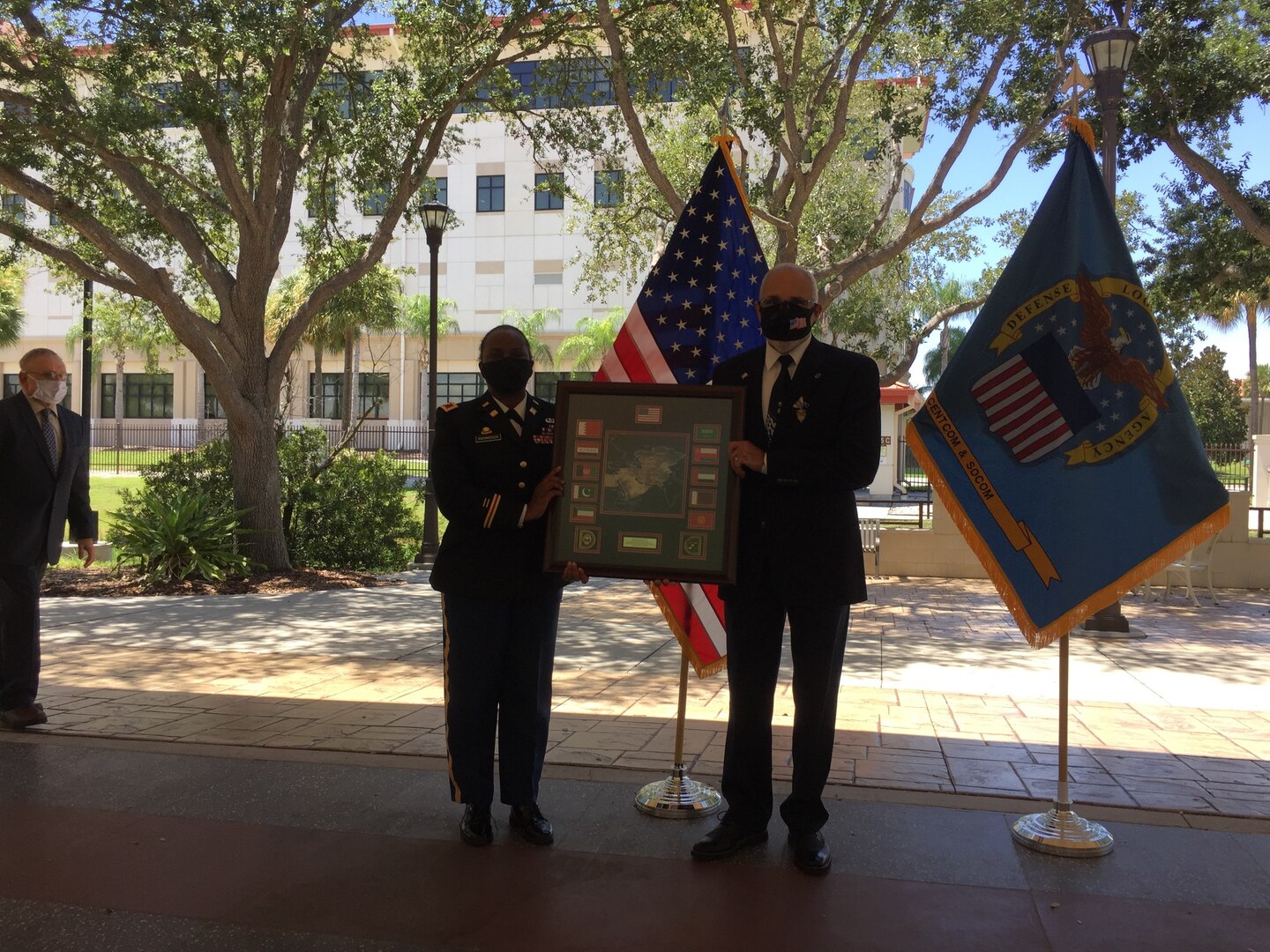 The commander presents the honoree with a departure plaque.