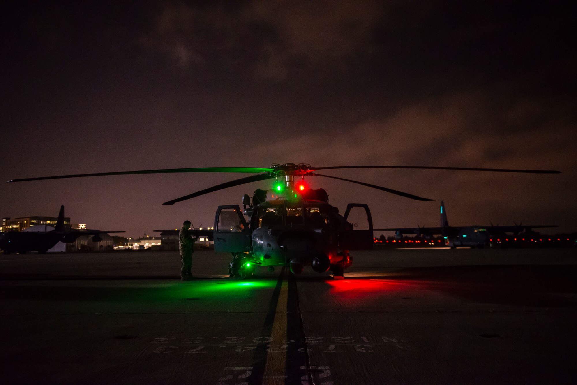 a photo of an HH-60 sitting on the flightline