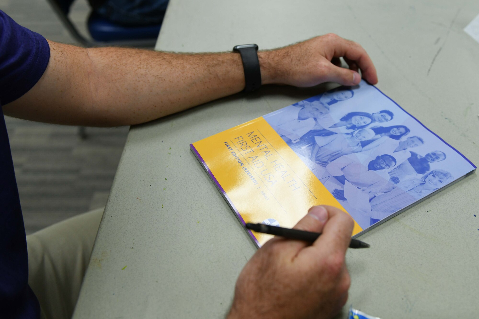 A person looks at a handbook