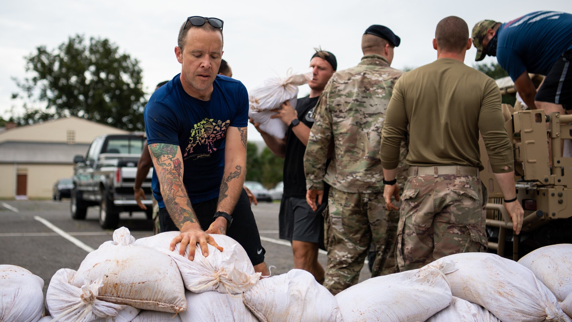 Airmen from the 2nd Security Forces Squadron unload sand bags at Barksdale Air Force Base, La., Aug. 28, 2020. The Airmen were part of a Disaster Response Force organized to help the base recover from damage caused by Hurricane Laura. (U.S. Air Force photo by Airman 1st Class Jacob B. Wrightsman)