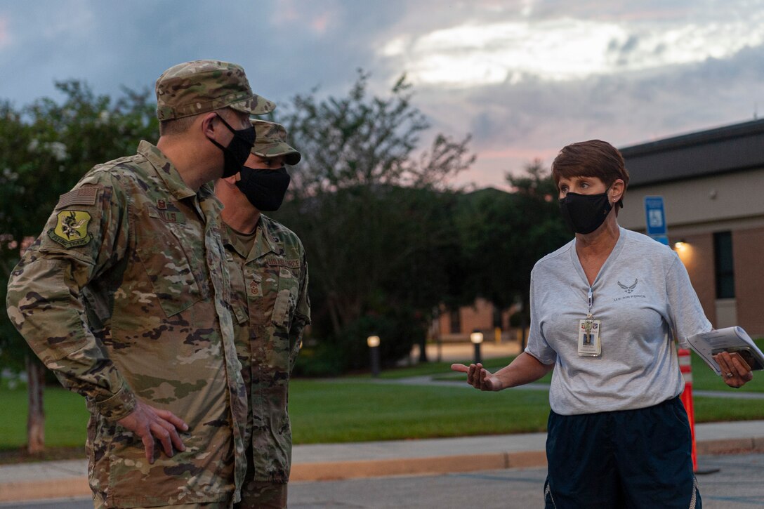 Photo of an Airman explaining COVID-19 POD line procedures