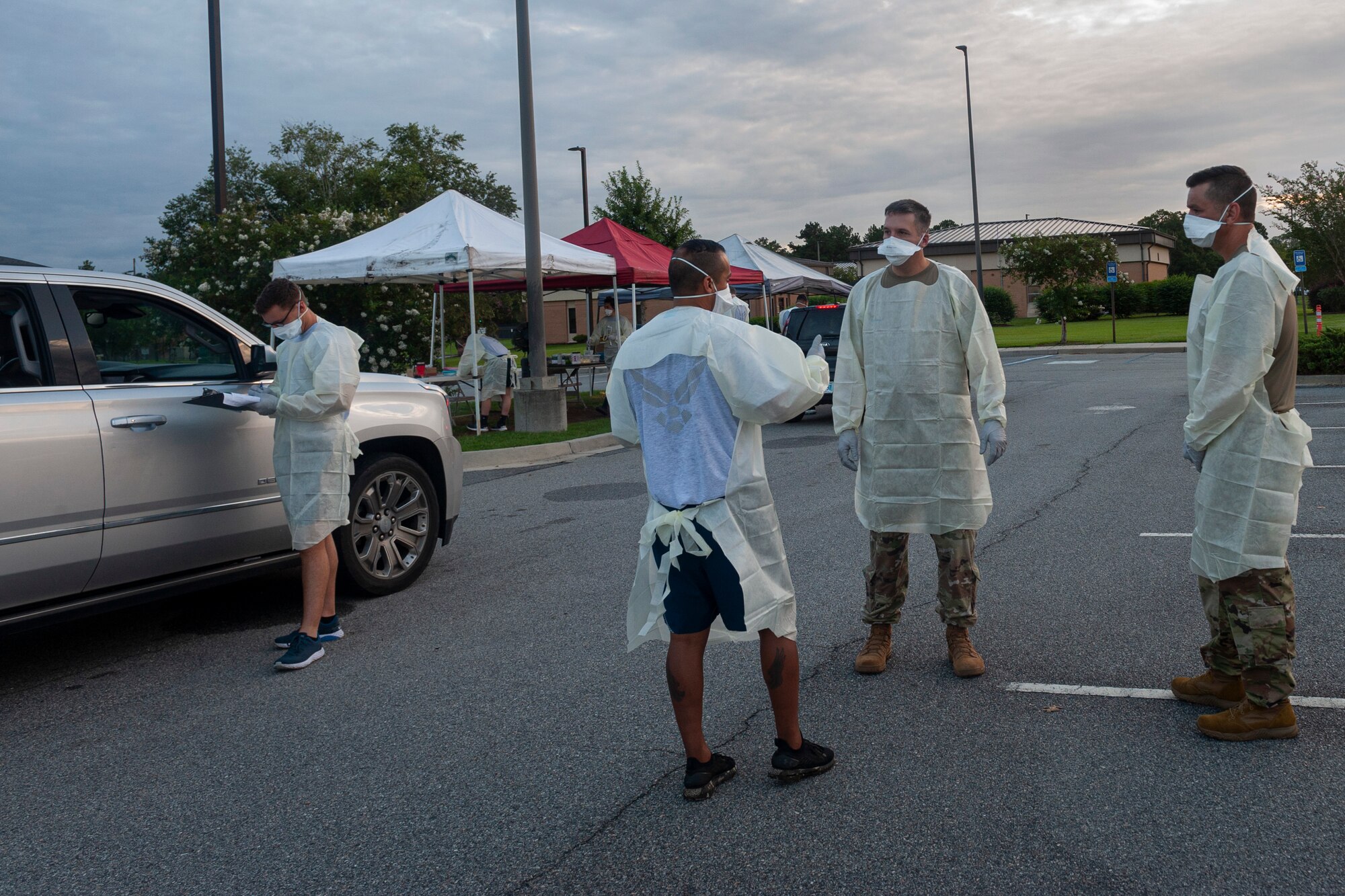 Photo of an Airman explaining COVID-19 POD line processes