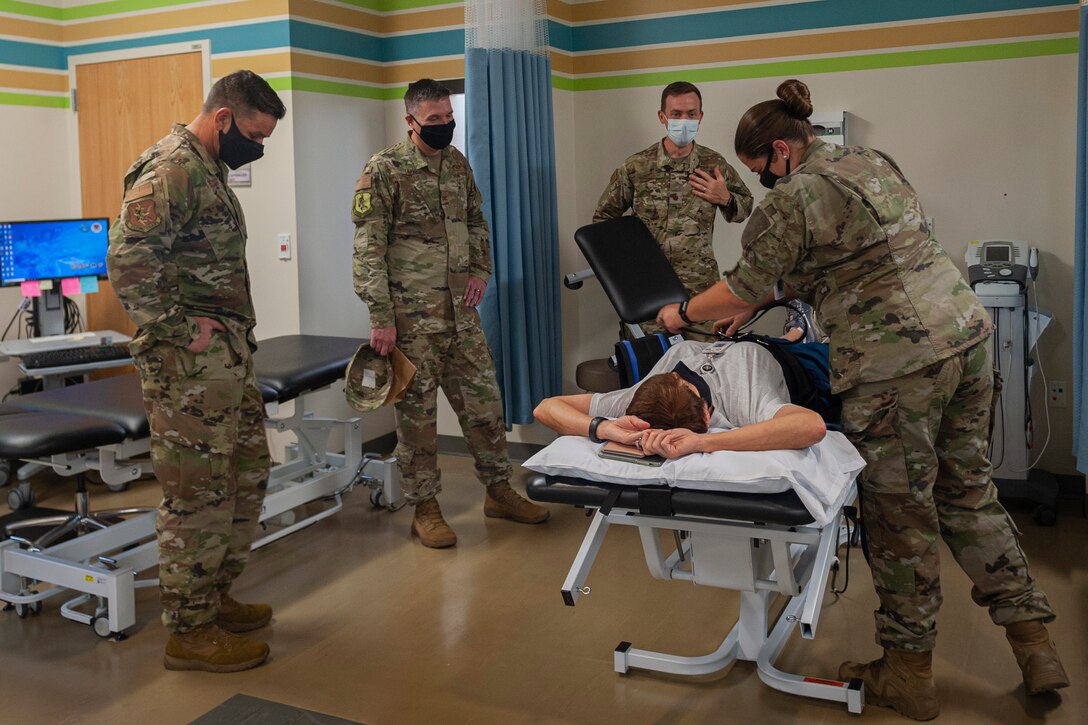 Photo of an Airman demonstrating a lumbar traction technique